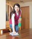 Brunette woman cleaning wooden furiture Royalty Free Stock Photo