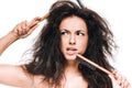 Brunette woman with combs in wavy unruly hair looking away isolated on white