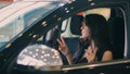 Brunette Woman dancing and smiling while sitting in car