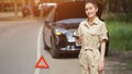 Brunette woman driver looks happy after calling tow truck Royalty Free Stock Photo