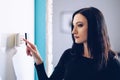 Brunette woman entering security pin on home alarm keypad Royalty Free Stock Photo