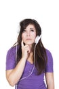 Brunette woman in headphones looking up dumbfounded