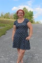 brunette woman in her forties wearing a summer dress on a beautiful summer day Royalty Free Stock Photo