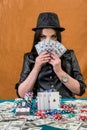 Brunette woman hiding her face under dollars fan Royalty Free Stock Photo