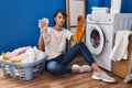 Brunette woman holding dirty socks skeptic and nervous, frowning upset because of problem Royalty Free Stock Photo