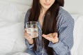 Brunette woman holding medication and glass of water Royalty Free Stock Photo