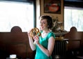 Brunette woman holding a pretzel