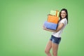 A brunette woman is holding three colourful gift boxes. Royalty Free Stock Photo