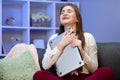 Brunette woman hug laptop computer, she love her work. Happy young girl,student hugging book, notebook, love studying Royalty Free Stock Photo