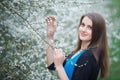 Brunette woman inhales the scent of flowers Royalty Free Stock Photo