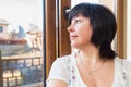 Brunette woman looking out the window Royalty Free Stock Photo