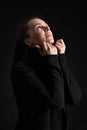 Brunette woman looking up in darkness. praying Royalty Free Stock Photo