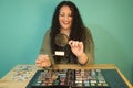 Brunette woman with a magnifying glass looking through her philatelic collection