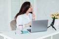 Beautiful brunette woman negotiating on laptop business online in office