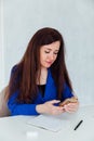 Beautiful brunette woman negotiating on smartphone business online in office