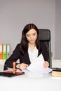 Brunette woman Notary Public reading testament. Royalty Free Stock Photo