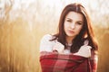 Brunette woman outdoors in check pattern plaid smiling Royalty Free Stock Photo