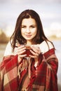 Brunette woman outdoors in check pattern plaid smiling Royalty Free Stock Photo