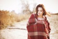 Brunette woman outdoors in check pattern plaid smiling Royalty Free Stock Photo