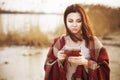 Brunette woman outdoors in check pattern plaid smiling Royalty Free Stock Photo