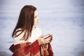 Brunette woman outdoors in check pattern plaid smiling Royalty Free Stock Photo