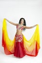 The dancer of east dances with bright scarfs fabrics Royalty Free Stock Photo