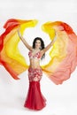 The dancer of east dances with bright scarfs fabrics Royalty Free Stock Photo