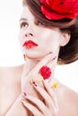 Brunette woman with poppy flower in her hair, poppy ring and creative nails, closed eyes