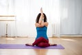 Brunette woman practicing eagle pose in yoga class Royalty Free Stock Photo