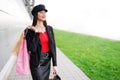 Brunette woman shopping bags while standing outdoors. Copy space Royalty Free Stock Photo