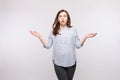 Brunette woman showing puzzled reaction.Studio portrait of brunette woman in casual clothes showing puzzlement or