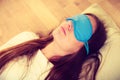 Brunette woman sleeping in blue eye sleep mask Royalty Free Stock Photo