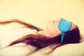 Brunette woman sleeping in blue eye sleep mask Royalty Free Stock Photo