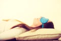 Brunette woman sleeping in blue eye sleep mask Royalty Free Stock Photo