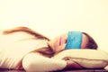 Brunette woman sleeping in blue eye sleep mask Royalty Free Stock Photo