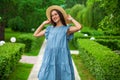 Brunette woman in a turquoise summer dress