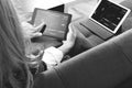 brunette woman using digital talet and laptop computer on sofa i Royalty Free Stock Photo