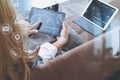 brunette woman using digital talet and laptop computer on sofa i Royalty Free Stock Photo