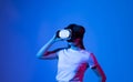 Brunette woman in VR glasses. Confident young woman in virtual reality headset pointing in the air while working in