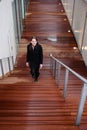 Brunette Woman Walking Up Stairs