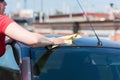 Brunette woman washes her car
