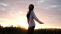 brunette woman in white blouse with baldric on summer field on sunset. peaceful time. millennial generation. calm female