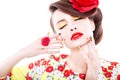 Brunette woman in yellow and red dress with poppy flower in her hair, poppy ring and creative nails, closed eyes