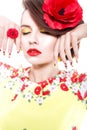 Brunette woman in yellow and red dress with poppy flower in her hair, poppy ring and creative nails, closed eyes Royalty Free Stock Photo