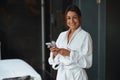 Brunette young entrepreneur female waiting for a spa procedure in room indoors Royalty Free Stock Photo