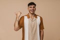 Brunette young man laughing and pointing finger aside Royalty Free Stock Photo