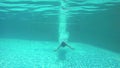 Brunette young slim woman jumps and swimming underwater in pool. 1920x1080