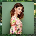 Brunette young woman in floral spring summer dress Royalty Free Stock Photo