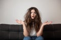 Brunette young woman with tangled long hair looks desparate and unhappy with her hairstyle, bad hair day concept Royalty Free Stock Photo