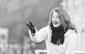 Attractive lady in white knitted coat and scurf. woman exited welcome on street.